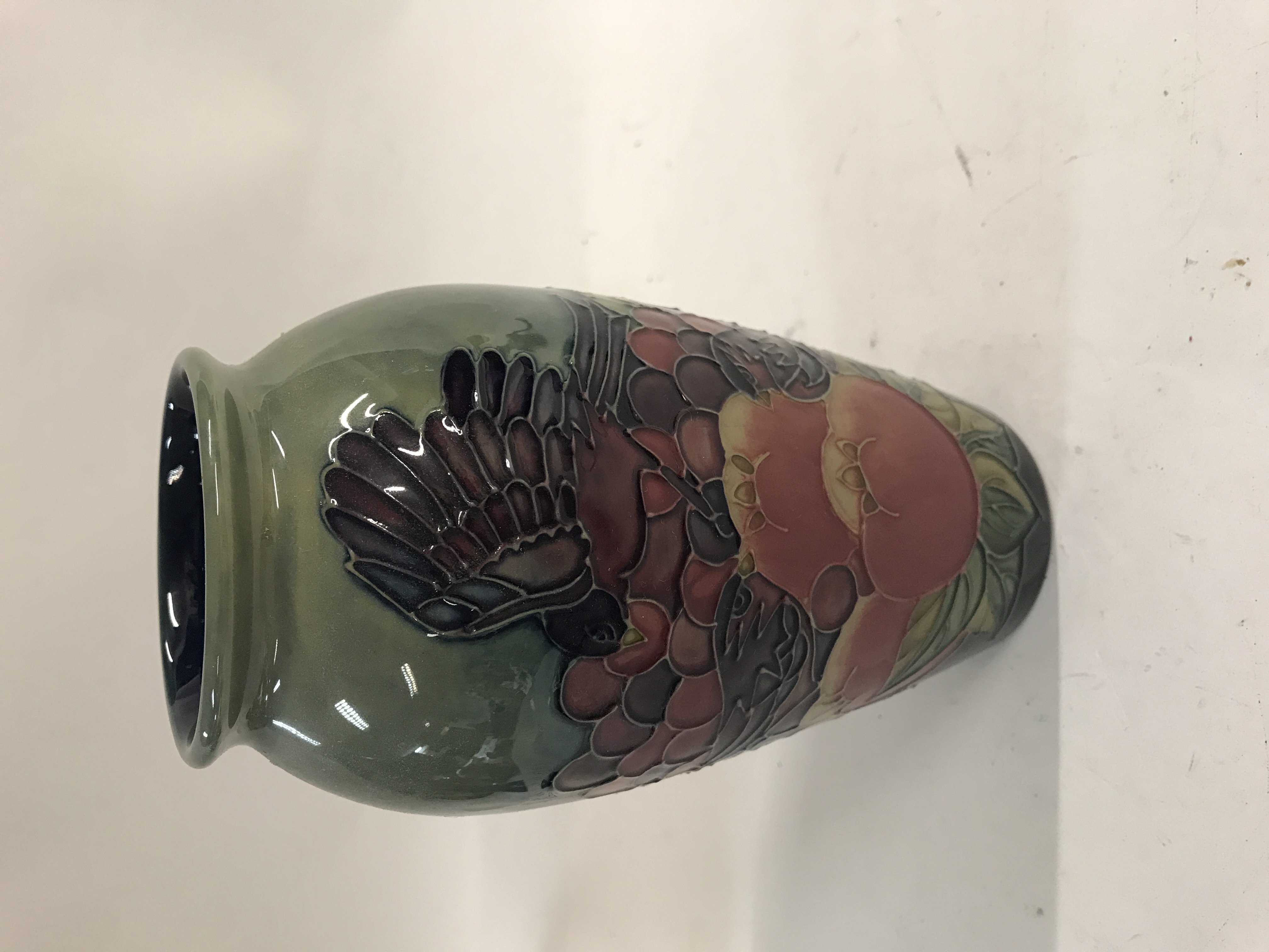 A moorcroft vase decorated with birds flowers and