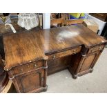 A large walnut veneered desk with replacement top,