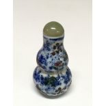 A Chinese scent bottle with a jade lid and small w