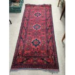 A hand knotted Turkish rug with three blue geometr