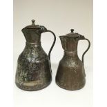 A pair of copper Islamic water jugs in two varying