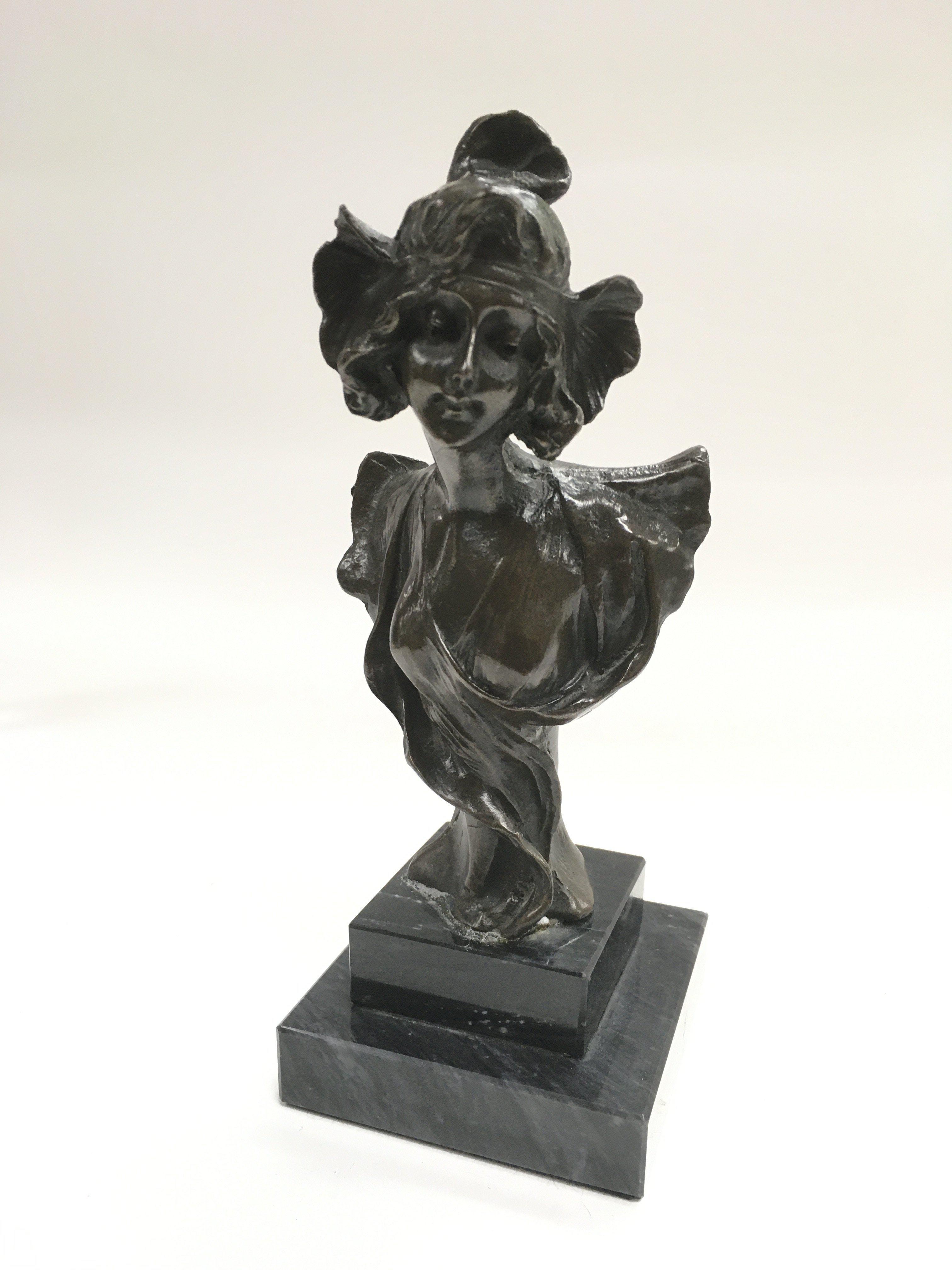 A spelter bust of an Art Nouveau lady raised on a