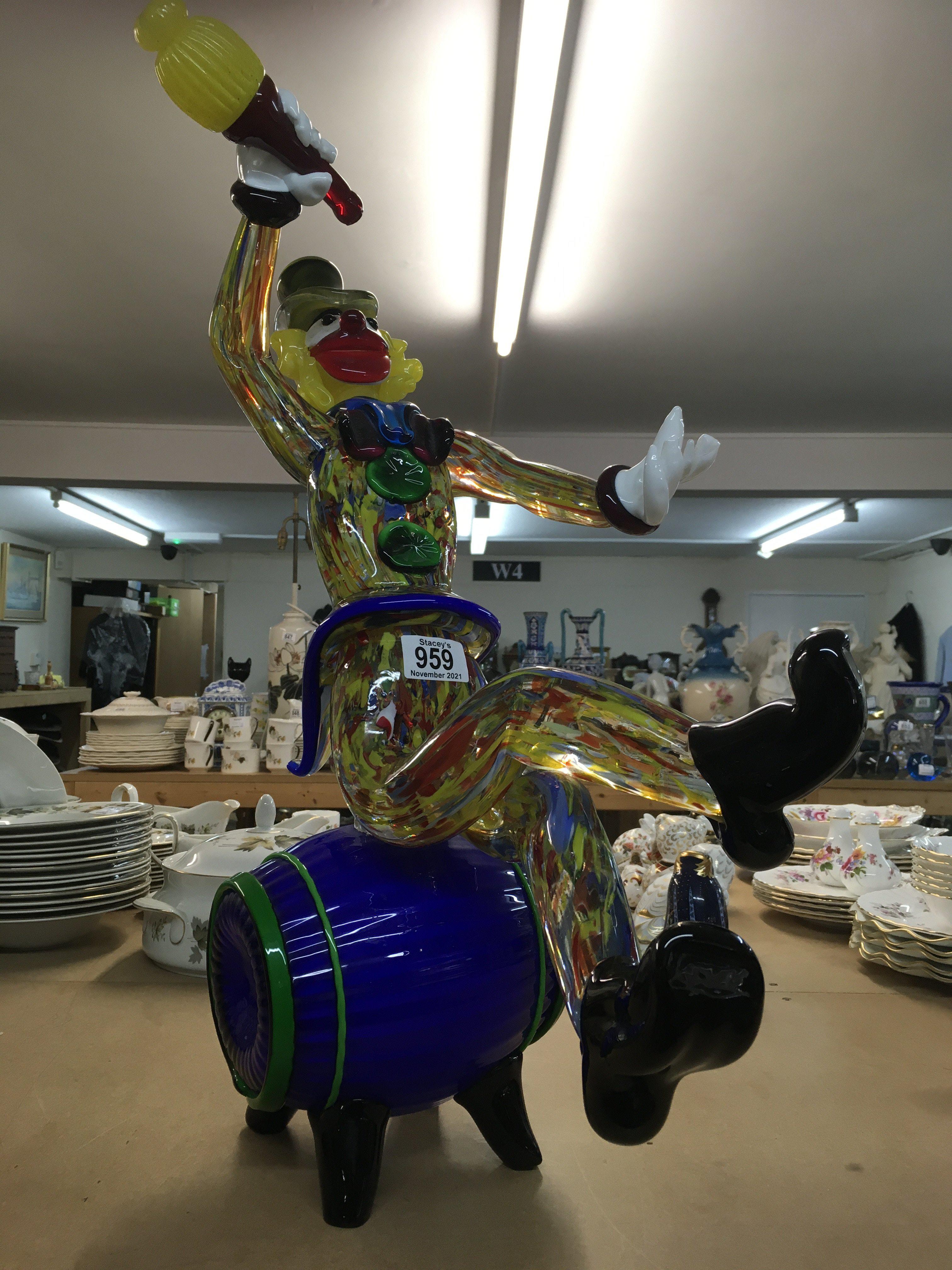 A Large Murano glass clown seated on a glass barre