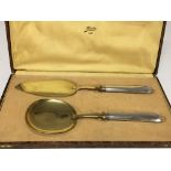 A pair of cased silver gilt French ice cream serve