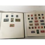 Two Green stamp albums containing world stamps and