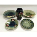 Four Moorcroft saucers comprising two in Fresia pa