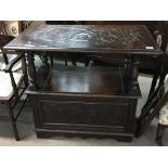 A carved oak hall seat/ table with an adjustable b