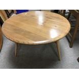 A Ercol low circular occasional table with single