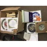 A box of collector's series ware plates.