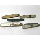 Five pocket knives, two with silver blades.