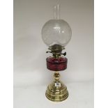 A Quality Victorian oil lamp with a cranberry glas