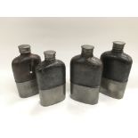 Four leather and pewter hip flasks.