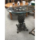 A composition occasional table with a glass top an