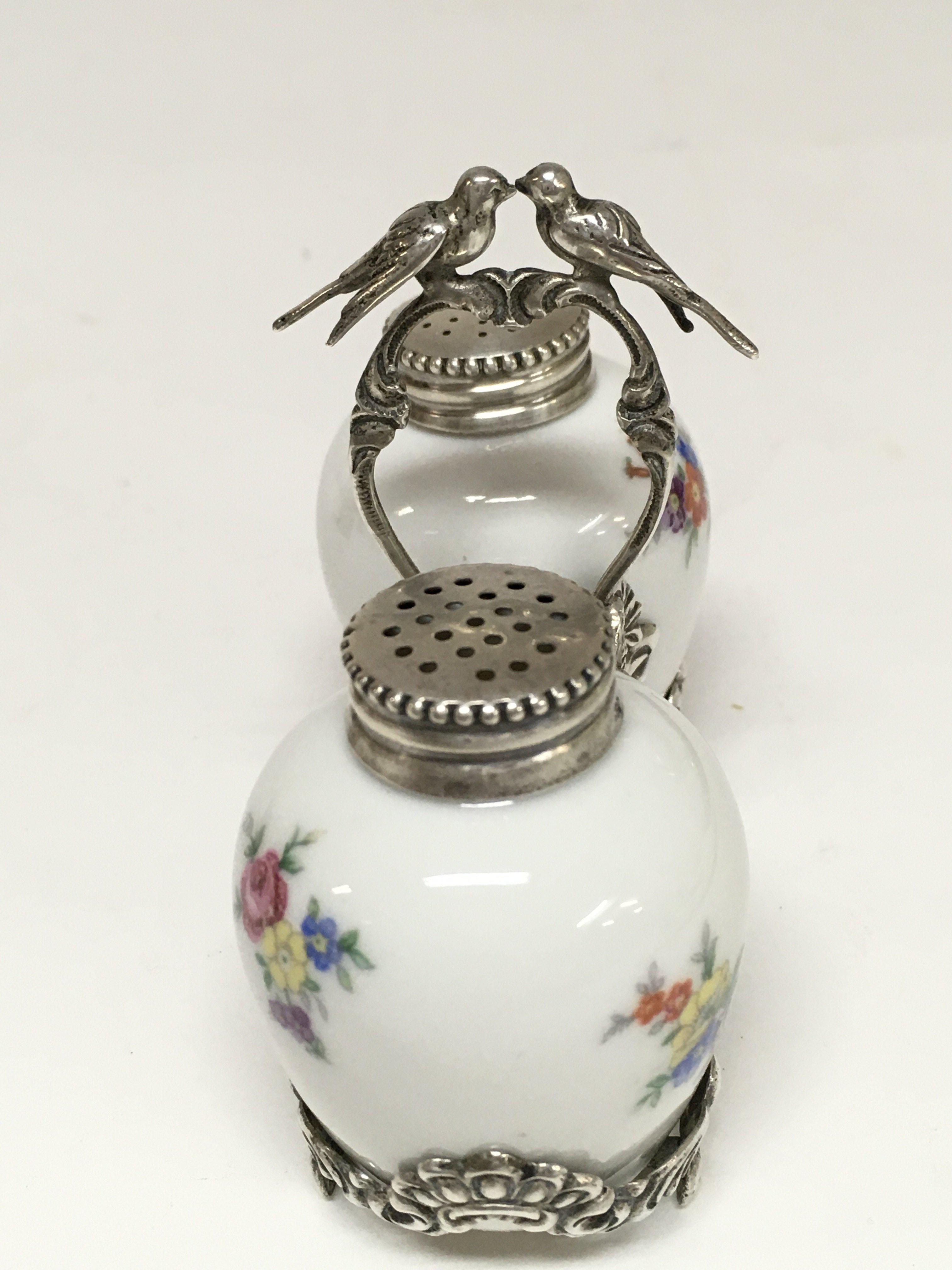 A set of salt and pepper shakers with silver holde - Image 2 of 2