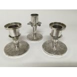 A set of three Malaysian white metal candle sticks