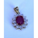 A 9ct yellow gold oval ruby and diamond pendant (r