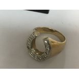 A 14 k yellow gold ring in the form of a horse sho