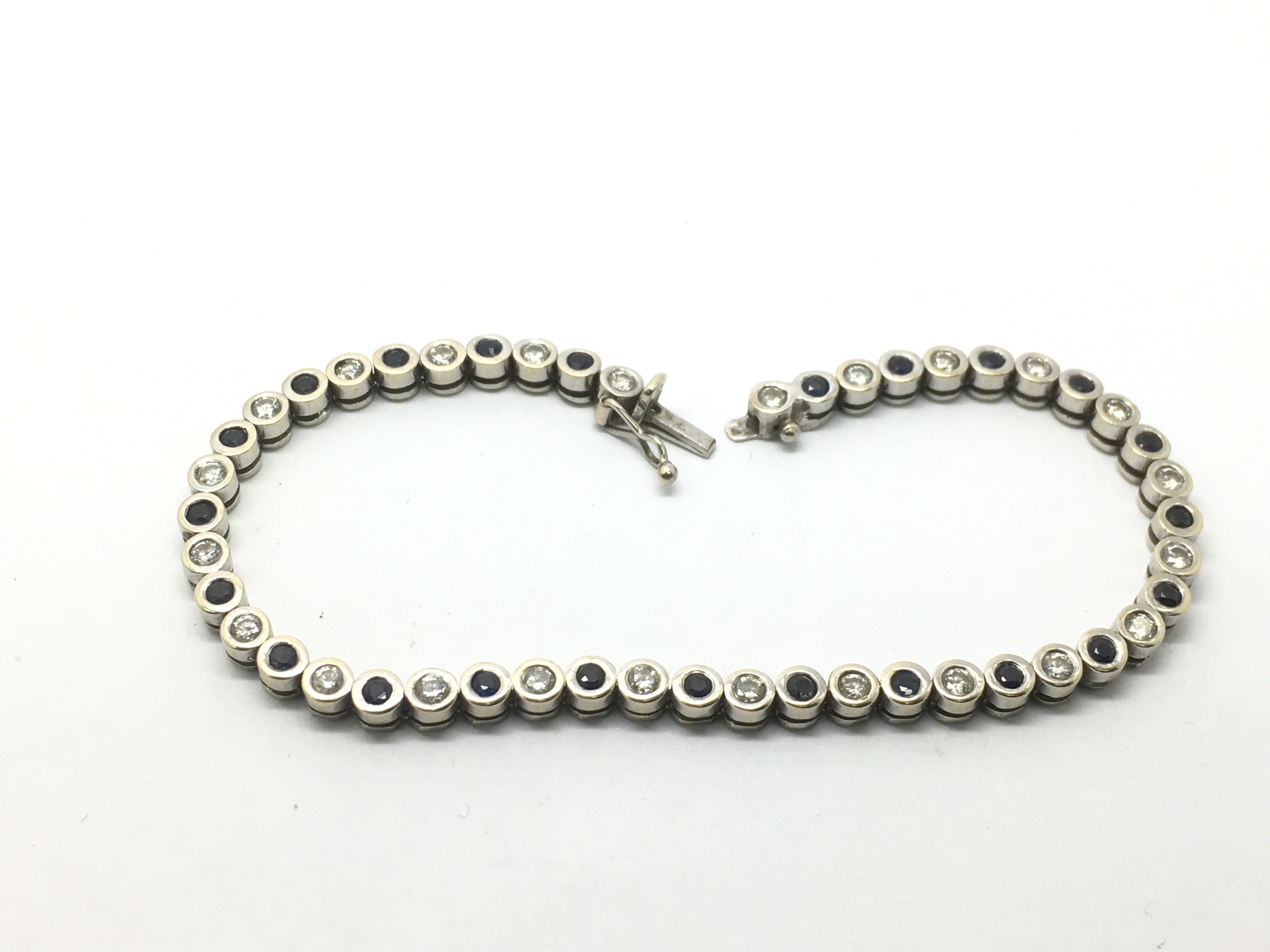 An 18ct white gold diamond and sapphire bracelet,