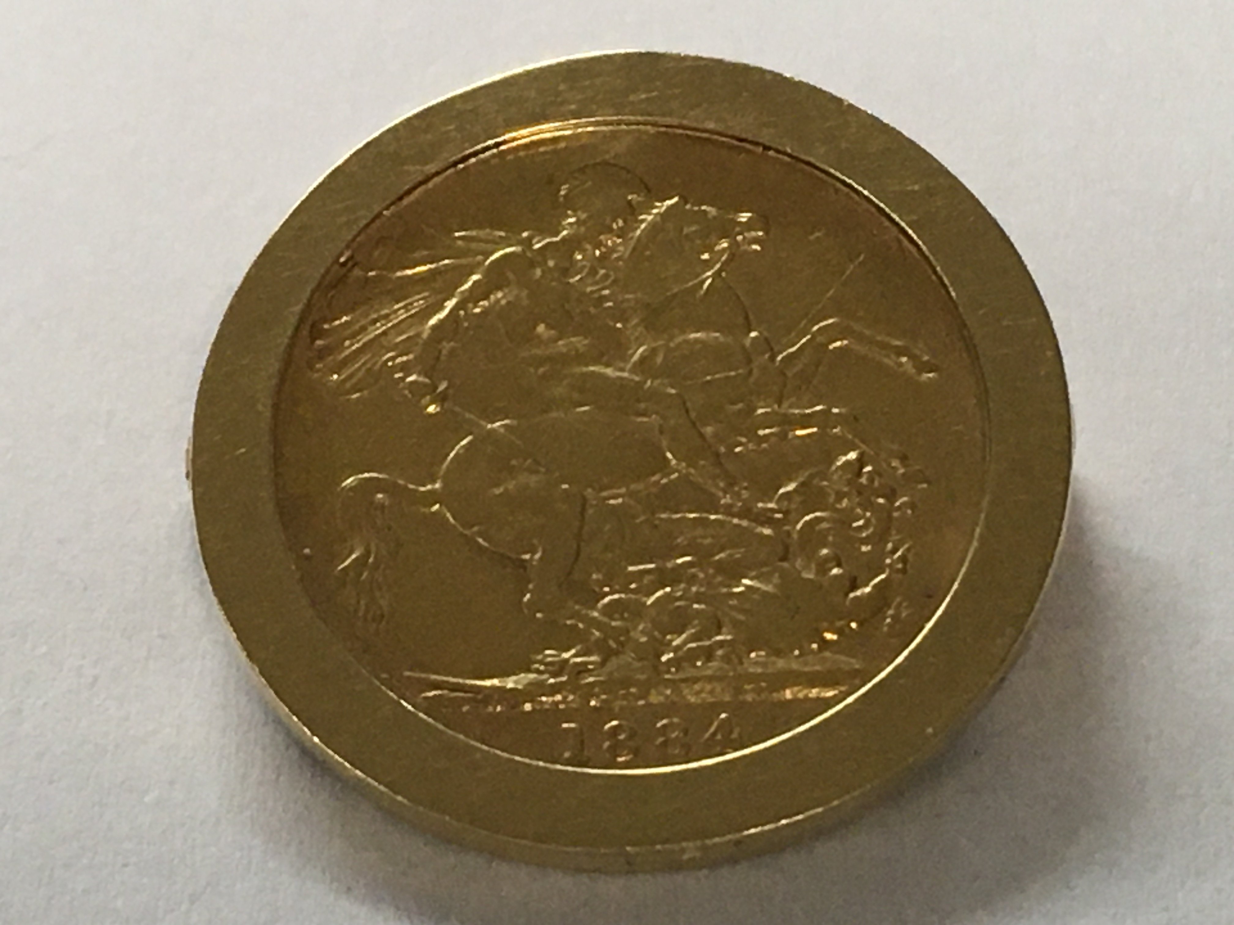 A gold sovereign fitted in a gold mount