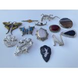 A collection of silver brooches, dragon & butterfl