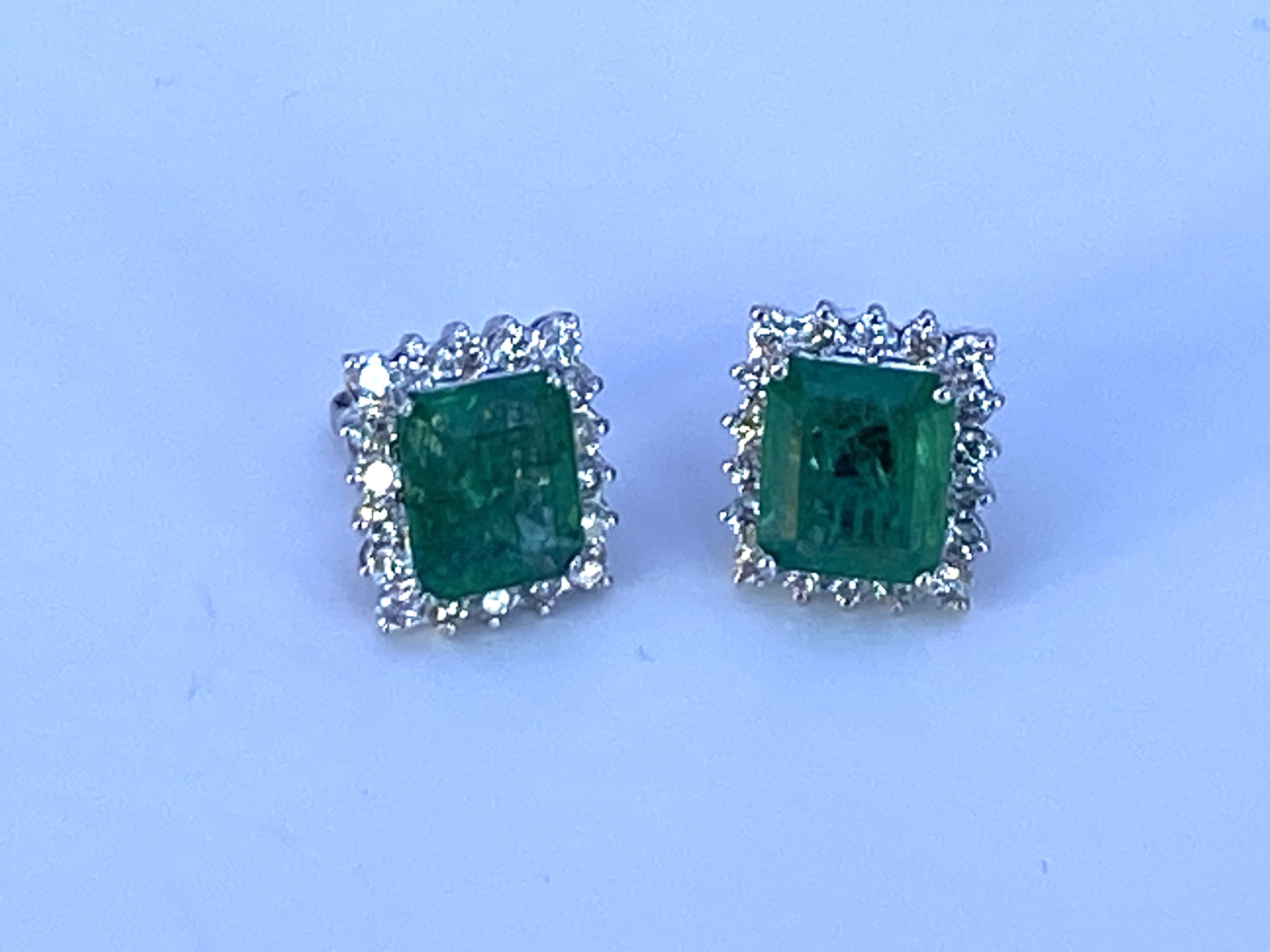 A pair of large 18ct white gold step cut emerald a