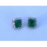 A pair of large 18ct white gold step cut emerald a