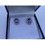 A pair of 9ct gold and oval cut Tanzanite and diam