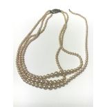 A Three string Pearl necklace, boxed. A/f as pictu