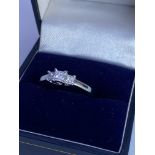 An 18ct white gold graduated 3 stone Princess cut