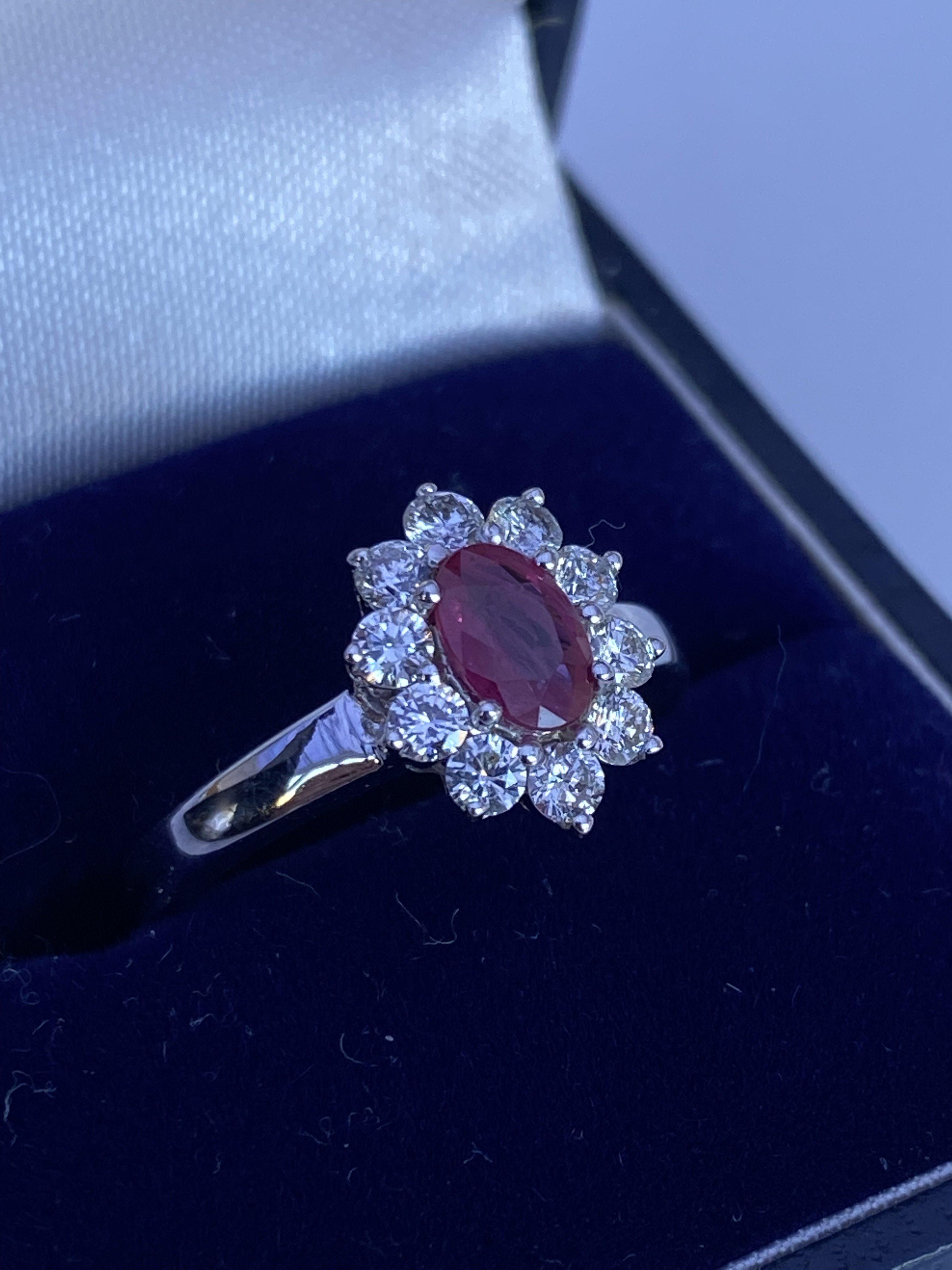 An 18ct white gold 0.50ct oval ruby and diamond cl