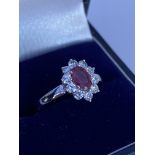 An 18ct white gold 0.50ct oval ruby and diamond cl