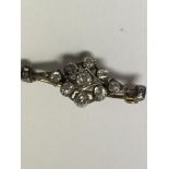 An Edwardian brooch inset with a cluster of diamon