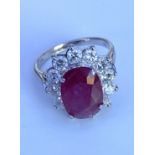 An 18ct gold large oval ruby and RBC diamond clust
