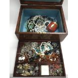 A jewellery box containing various costume jewelle