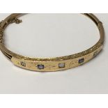 A Edwardian style gold bracelet unmarked 9 ct inset with diamonds and sapphire.9 grams approx .