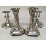 A pair of white metal candle sticks loaded bases L