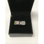 A silver multi gem stone ring size L .