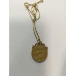 A gold mounted sovereign on chain total weight 12.