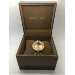 A boxed Gucci ladies bamboo watch with manual.