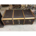 A wooden bound travelling trunk, approx 90cm x 51cm.