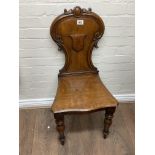 A Victorian oak hall chair.