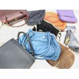 A mix of leather and suede handbags along with a g