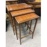 A Quality graduating nest of three Edwardian occasional tables the parquetry tops on square