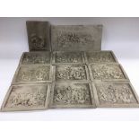 A box of marble plaques depicting putti.