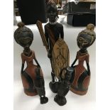 A collection of five tribal figures.