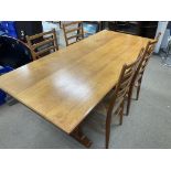 A 1930s oak refectory table together with 4 rush seated ladder backed dining chairs.