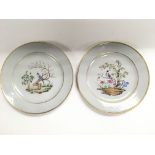 A pair of Oriental style plates decorated with bir