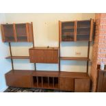 A floating display unit comprising glazed cupboards above shelving with cupboards under, to be