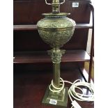 A Victorian brass oil lamp with a Corinthian colum