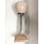 An Art Deco table lamp with a pink glass shade tog